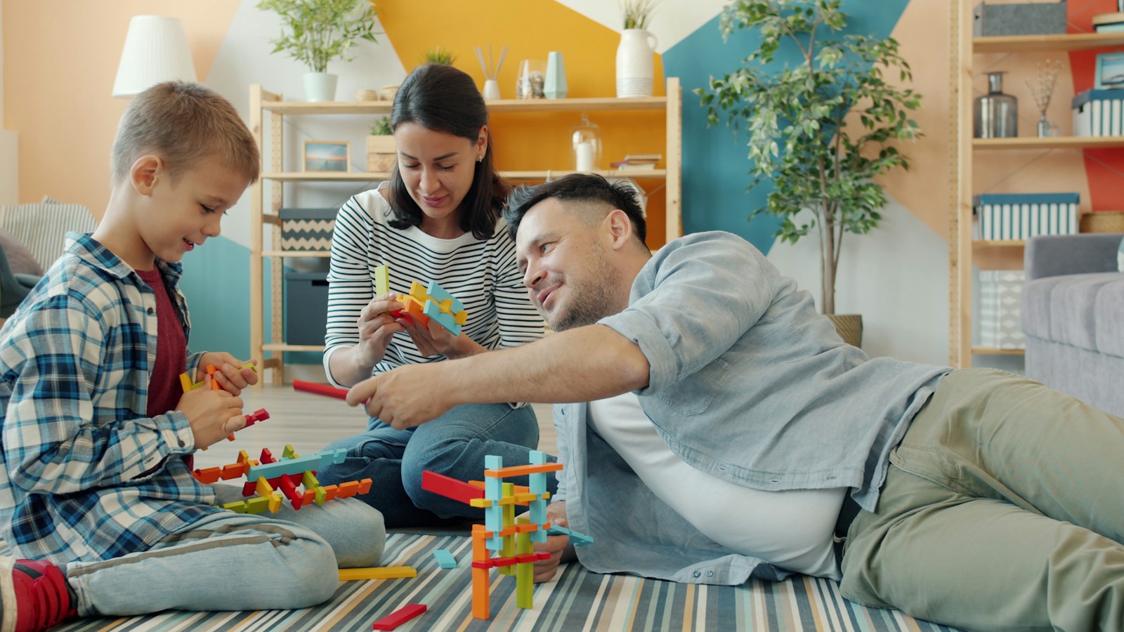 Family playing together on a clean living room floor